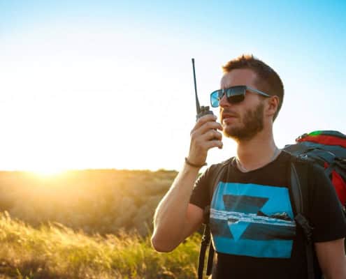 A guy using a long-rang two-way radio in a remote location