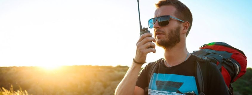 A guy using a long-rang two-way radio in a remote location