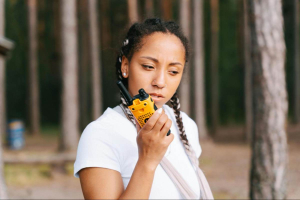  a woman using an environment-friendly two-way radio in the forest