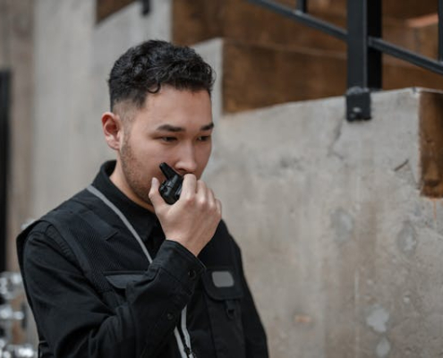 A person holding a black two-way radio