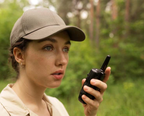 side view woman holding walkie talkie