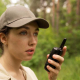 side view woman holding walkie talkie