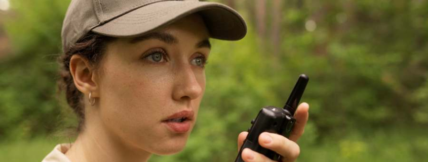 side view woman holding walkie talkie