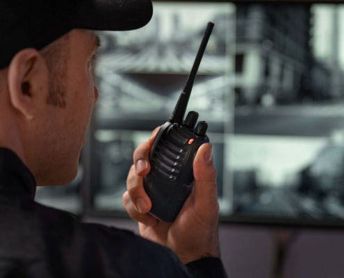 A man holding a black two-way radio