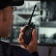 A man holding a black two-way radio